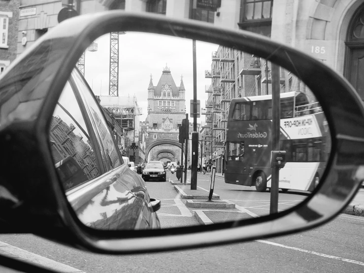 black and white po of traffic through rear view mirror