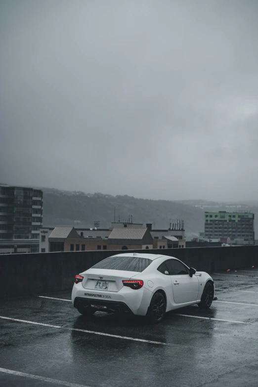 car parked in parking lot with city skyline in the background