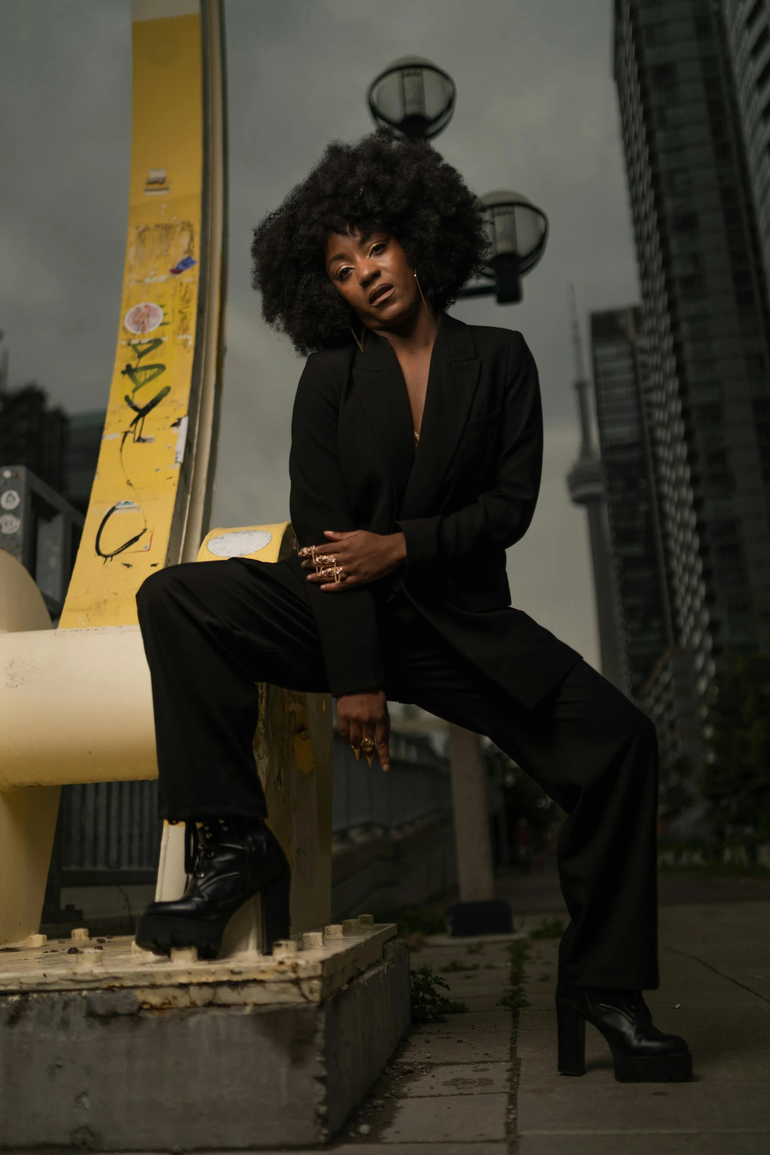 a woman sitting in a suit outside