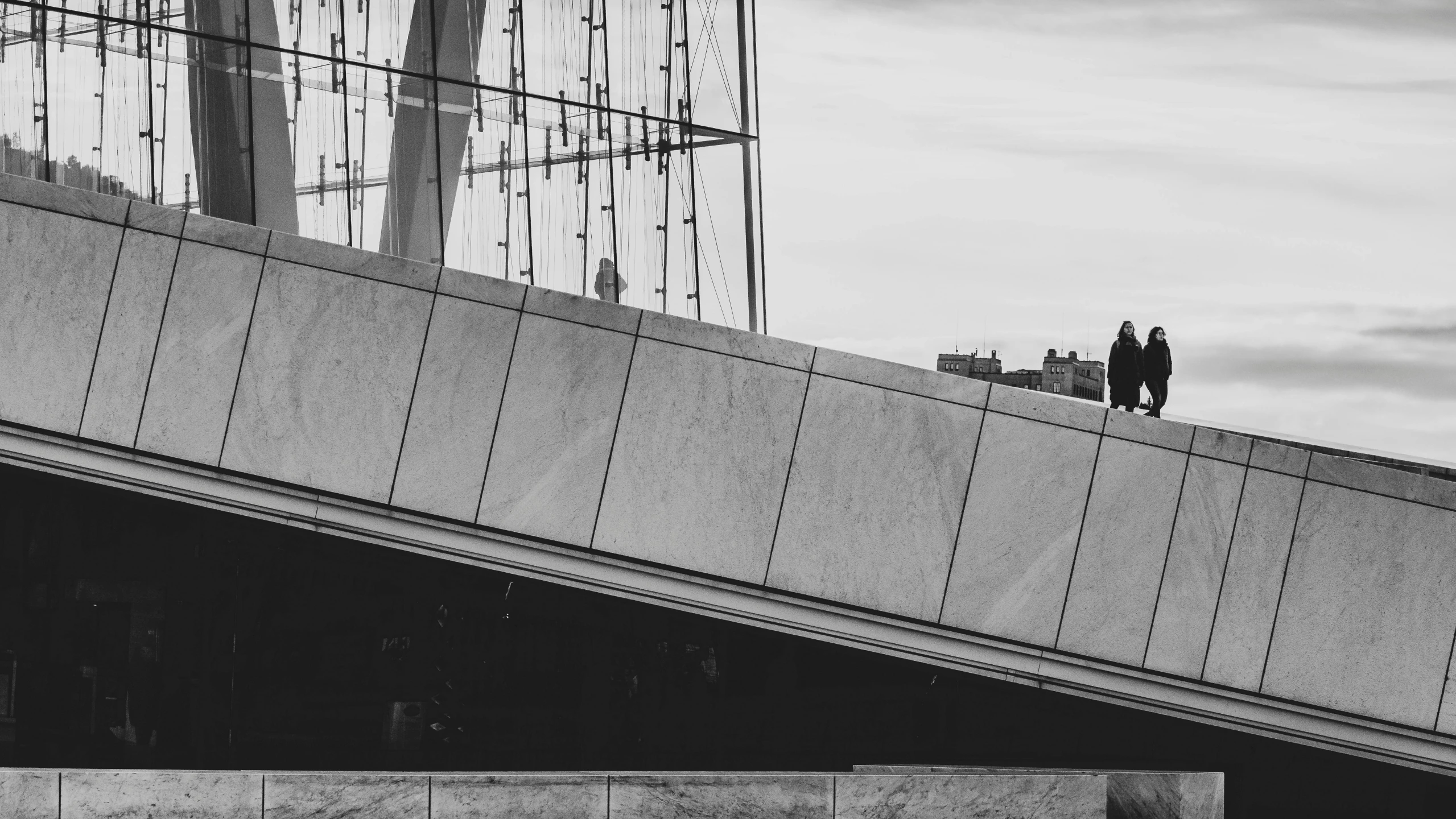 the man is standing on the bridge by himself