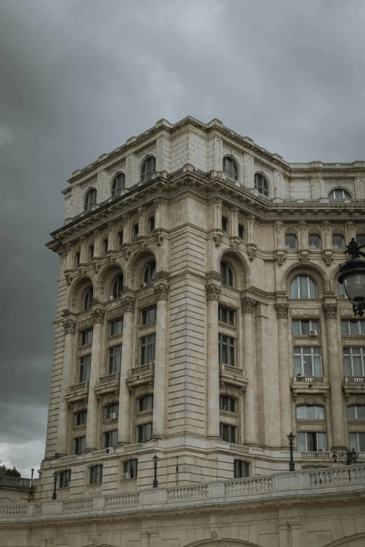 there is a tall building on a cloudy day