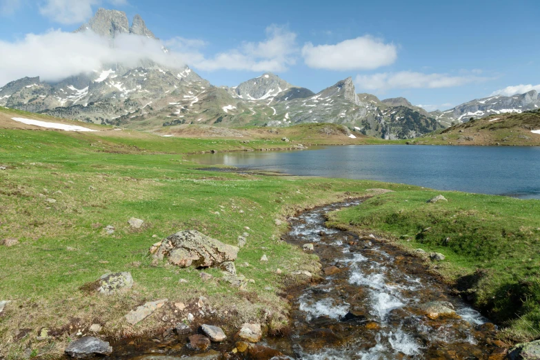 a mountain that has a small stream coming out from it