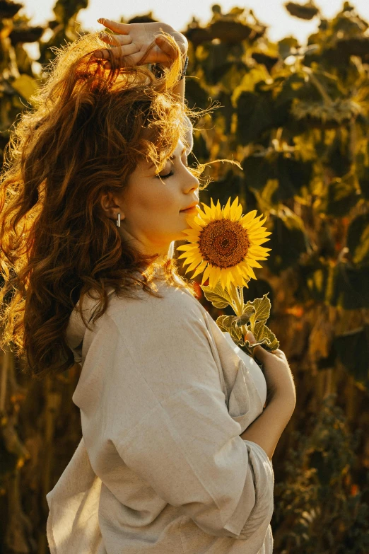 a woman is holding a flower in her right hand