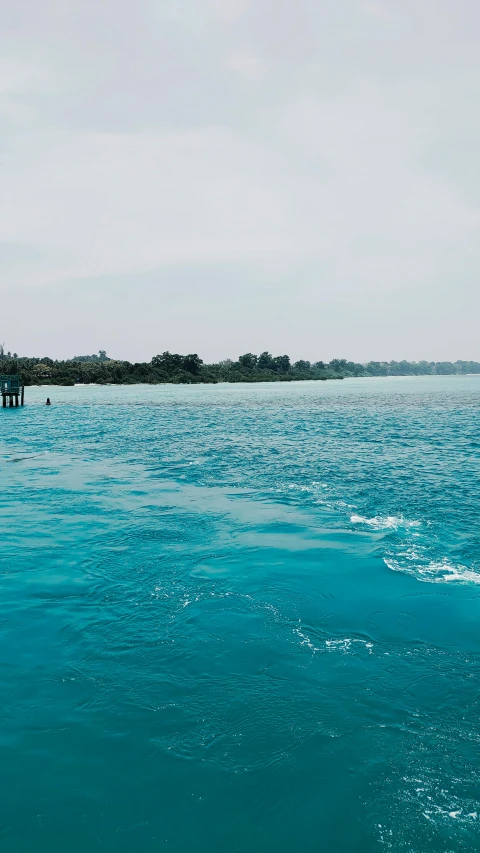 some very pretty blue water and an island