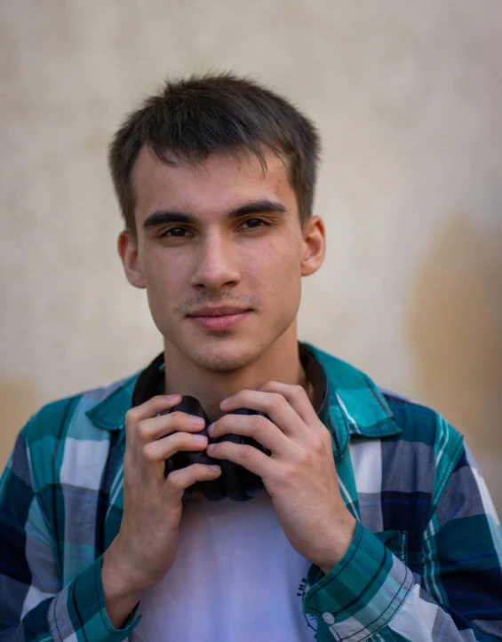 a man standing and wearing a green shirt posing for a picture