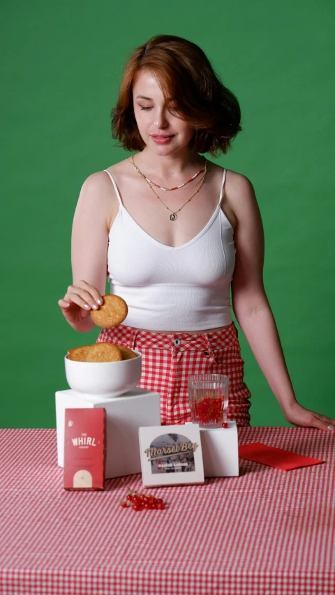 a young woman is eating food with her hands