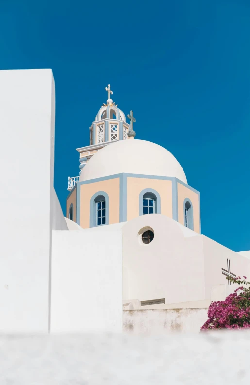 a white building with blue and yellow trim on top