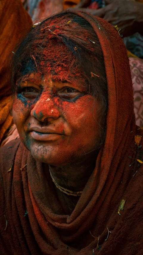 woman with face painting in red, blue and yellow