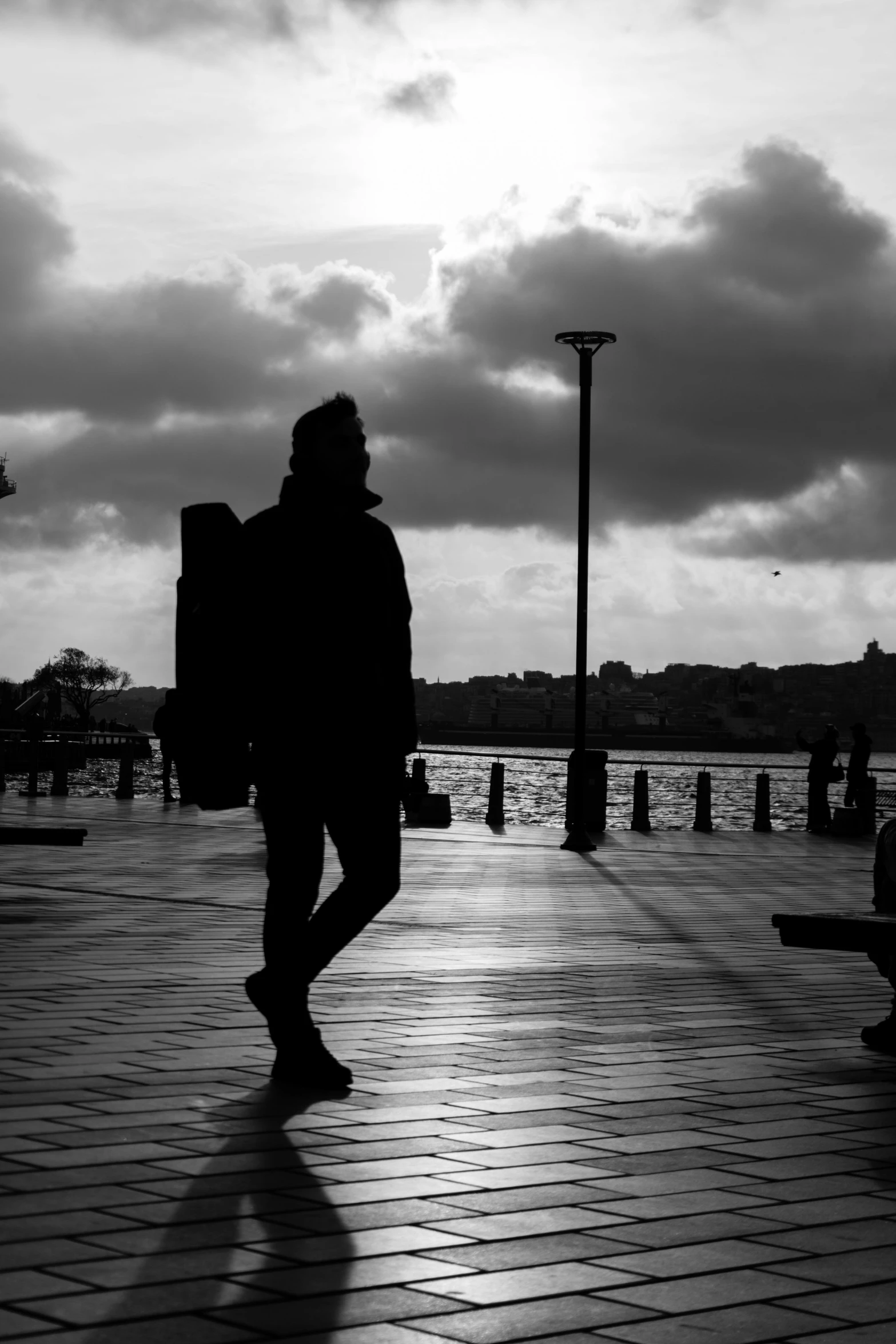 a person walking across a street with a skateboard