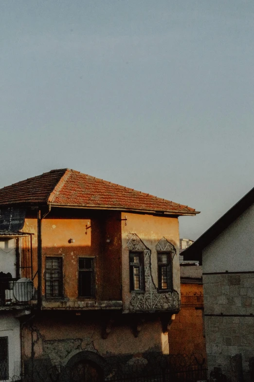 the building is made up of brown stucco and stone