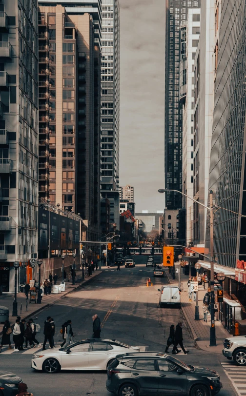 an old image shows a busy street in the center of tall buildings