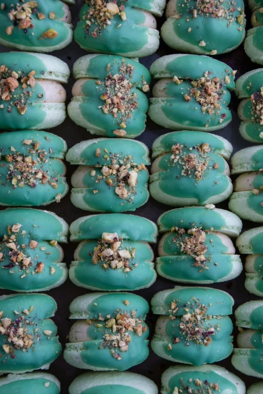 doughnuts decorated in teal and brown are piled up