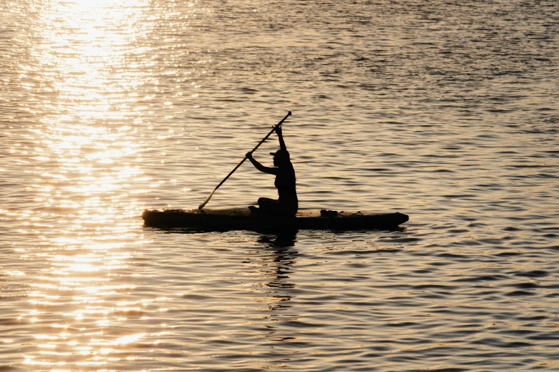 a person paddling a kayak in a large body of water