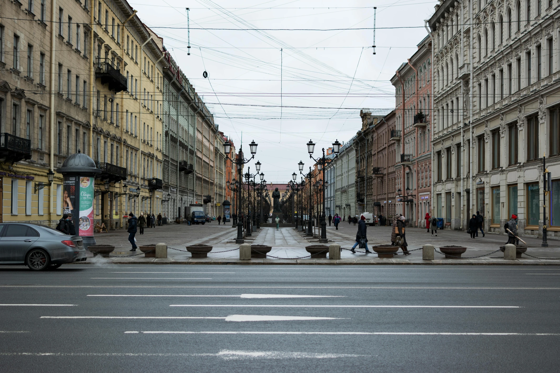 a city street with traffic, people and buildings