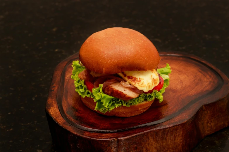 a chicken sandwich sitting on a wooden stand