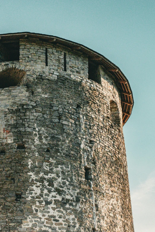 the corner of a tower is looking up into the blue sky