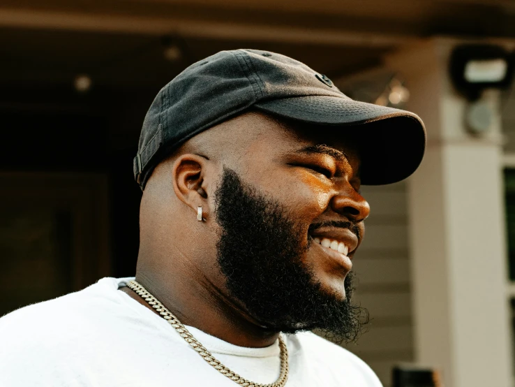 a man with a beard and wearing a baseball cap