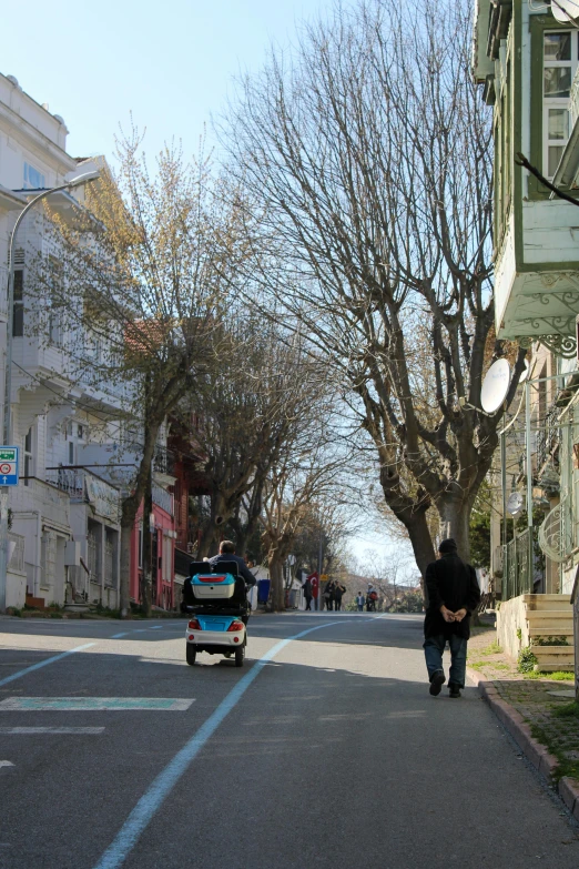 a car and a man walking down the street