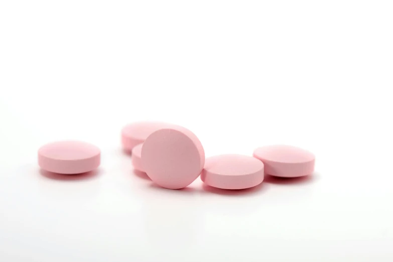 several pink pills arranged around one another