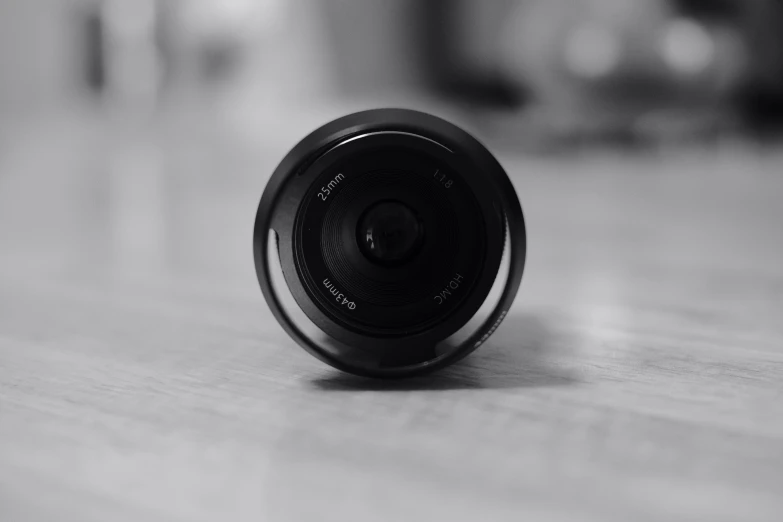 the top view of a camera lens that is on a wood floor