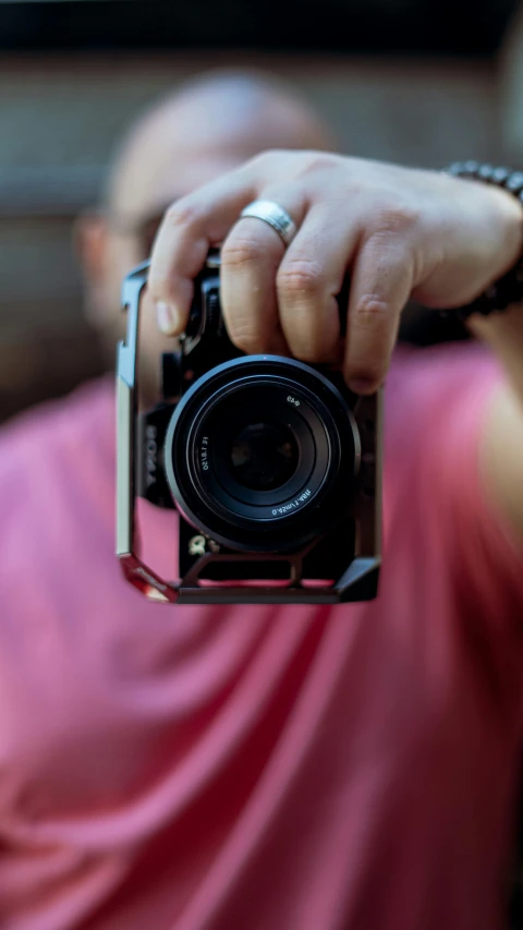 person holding up a camera with both hands