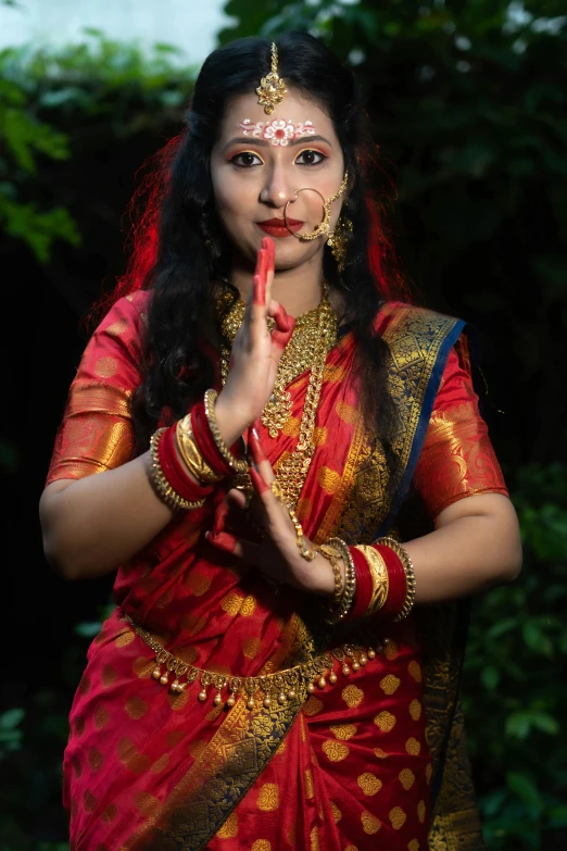 a woman with painted lips and red and yellow sari