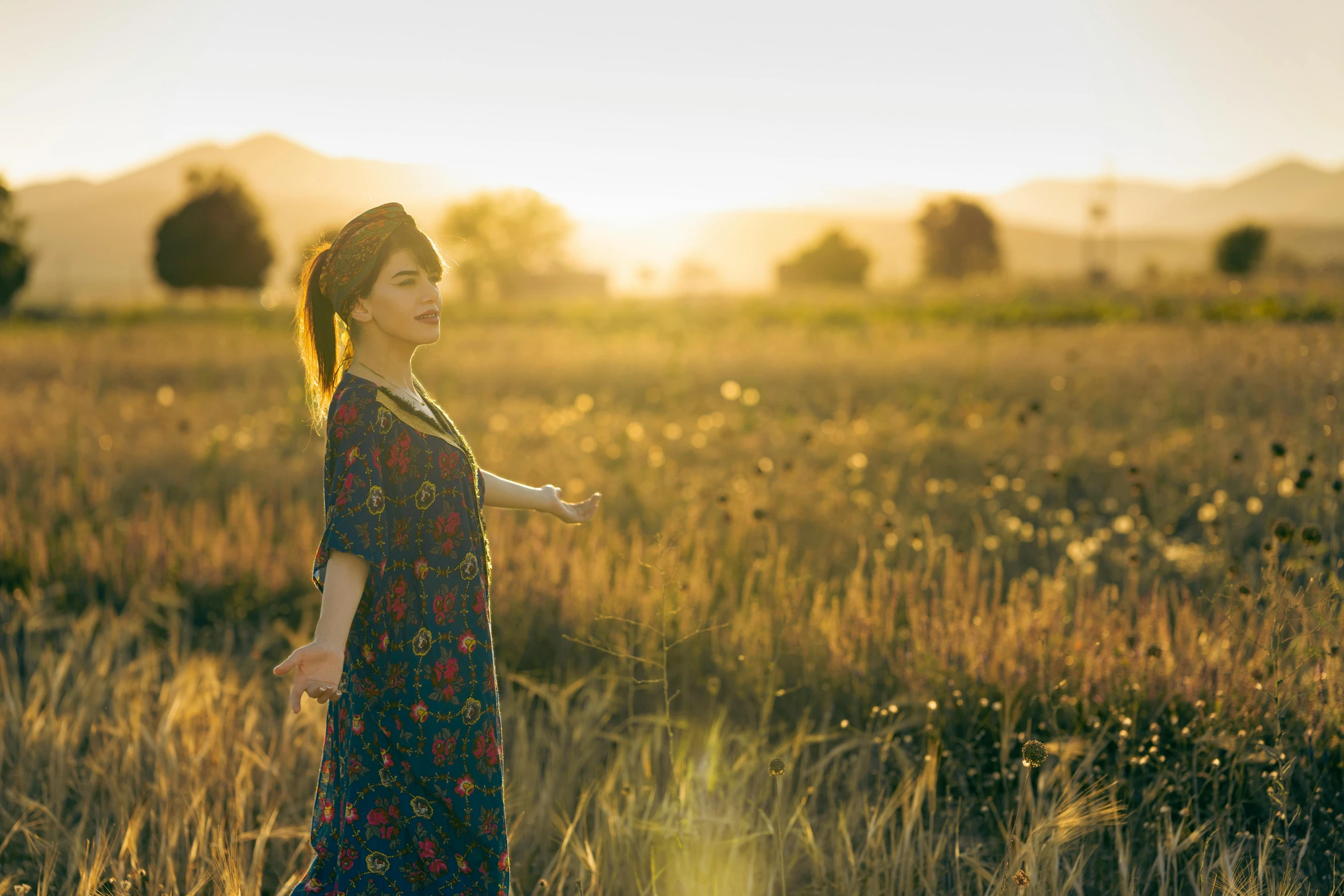 there is a girl in a field with sunbeams