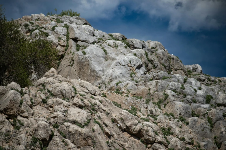 a pile of rock formations with trees on top