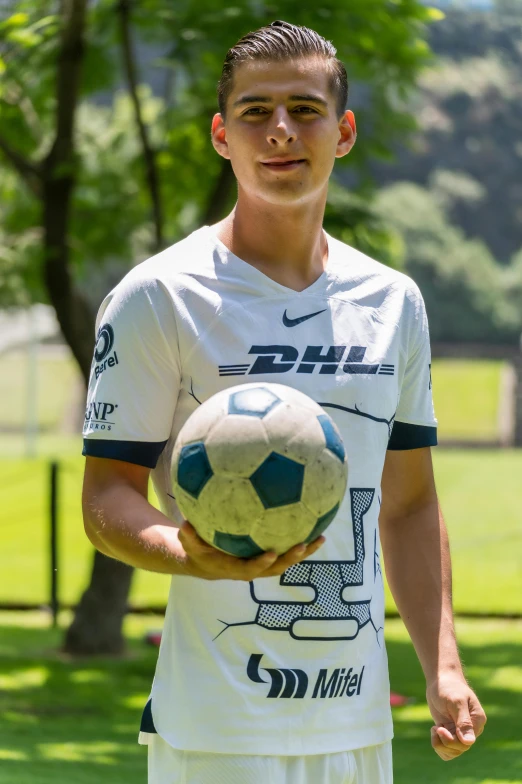 a soccer player with a ball on his arm