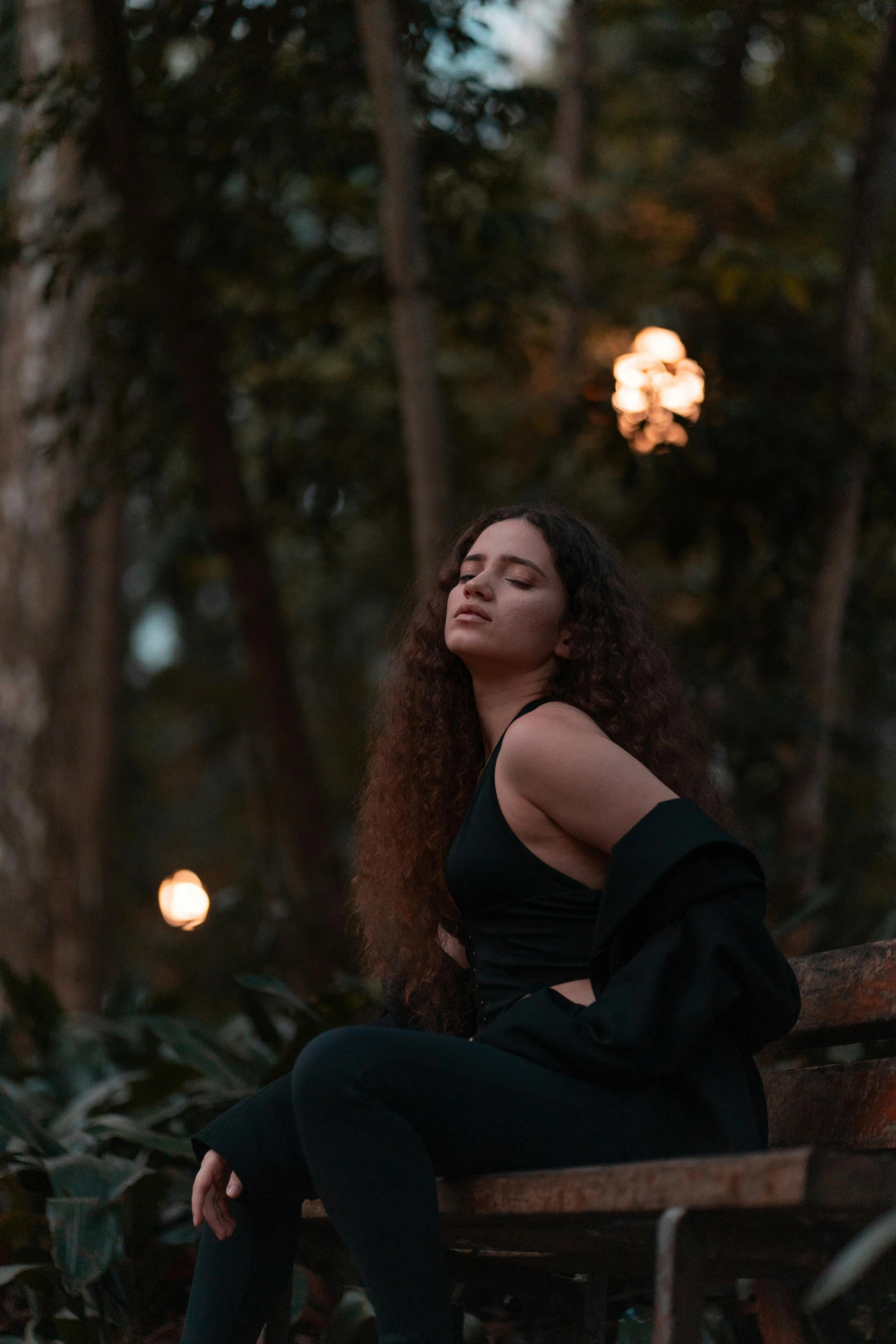 woman sitting on a bench with her head tilted to the side