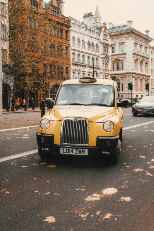 a taxi is driving down the city street