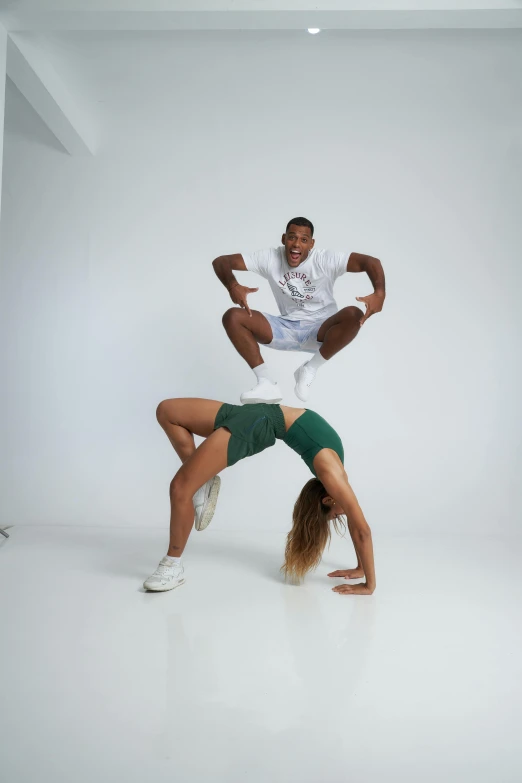 two women in white shirts and green skirts doing tricks