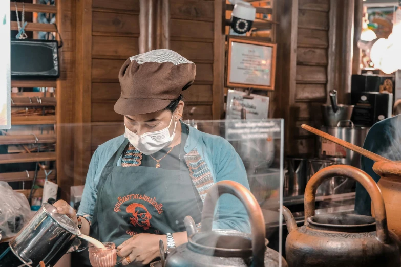 a woman is holding a tea pot in a shop