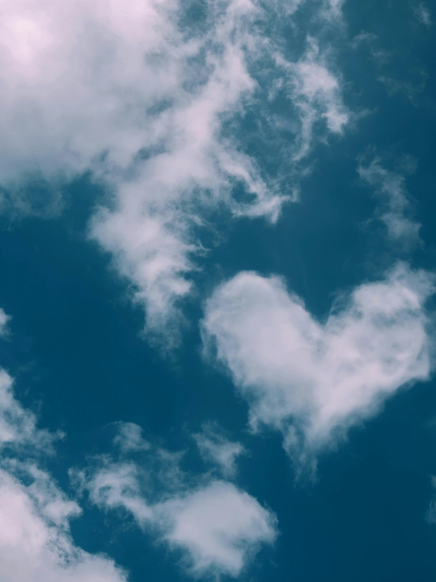 an airplane flying in the air near clouds