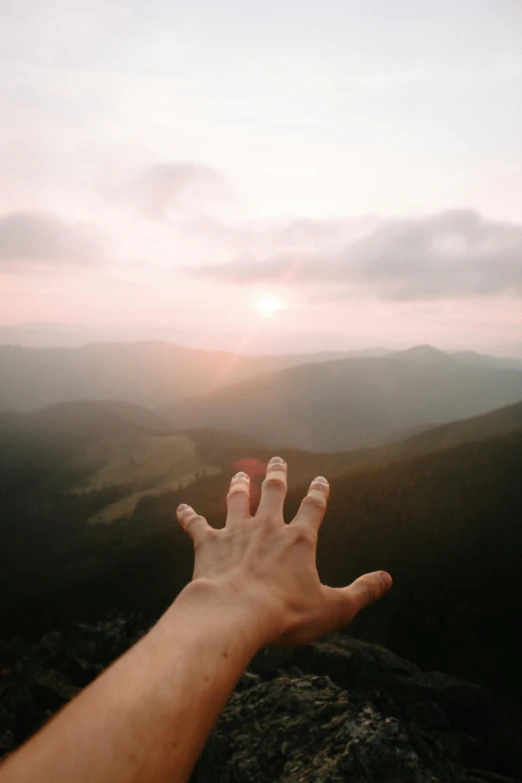 a hand reaching out towards the distance