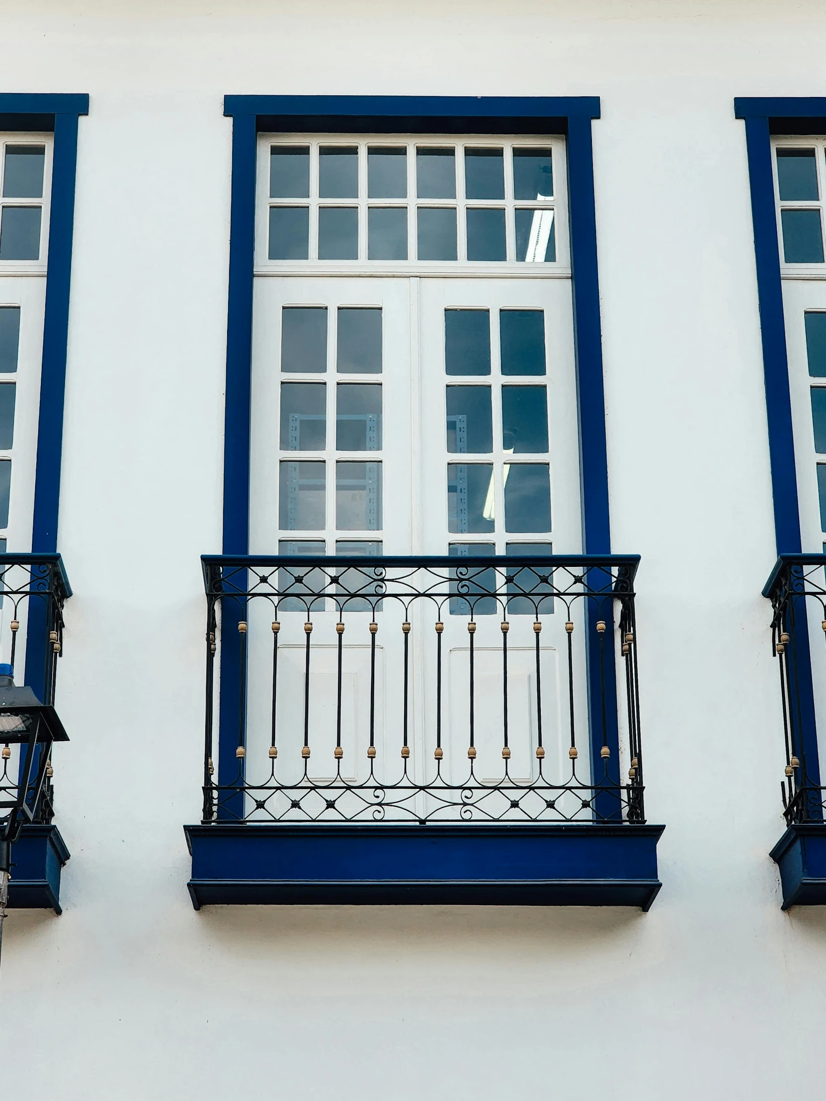 a building has two blue and white balconies