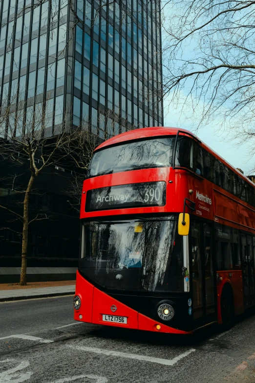 a double decker bus in front of tall buildings