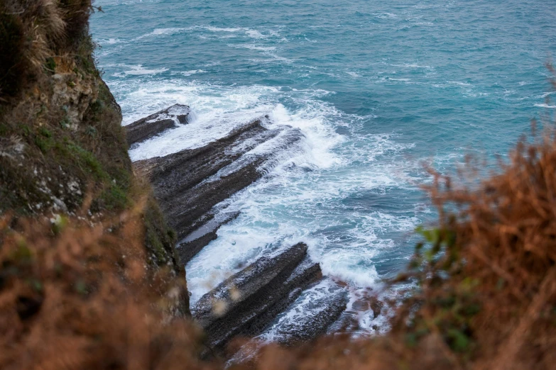 waves crashing on the rocks along a rocky shore