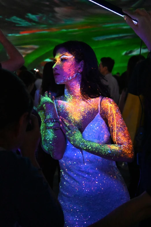 woman covered in glow paint at a party