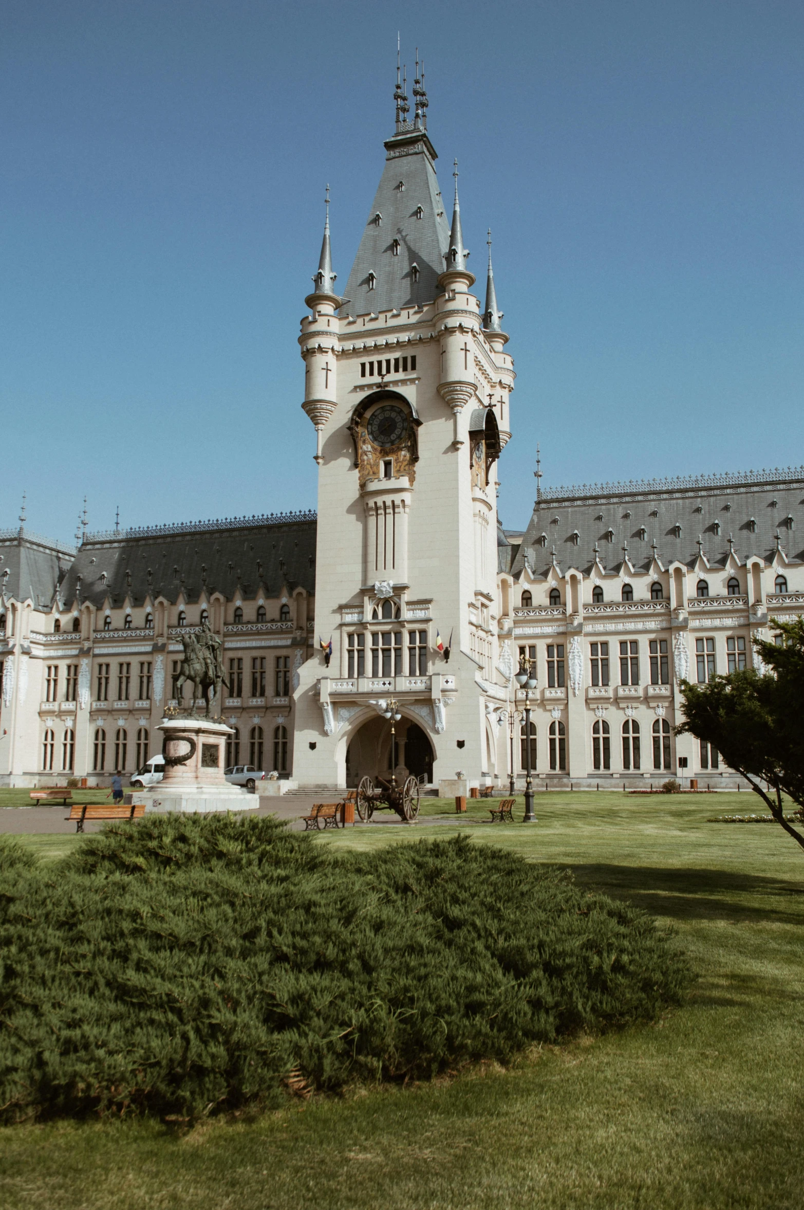 a clock tower in front of a castle like structure