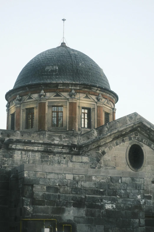 a building that has a tower and a dome on it