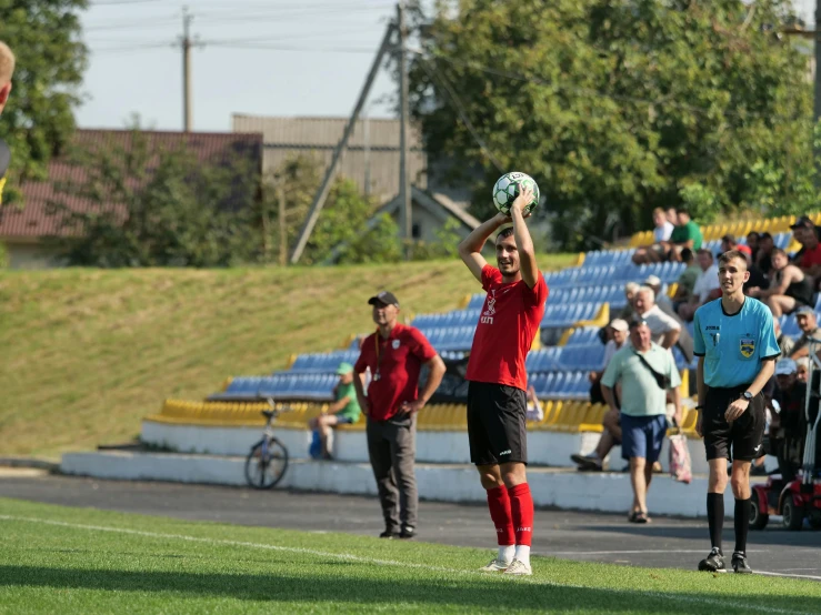 some people watching the people play soccer