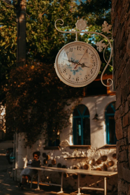 a large clock is on a wall outside