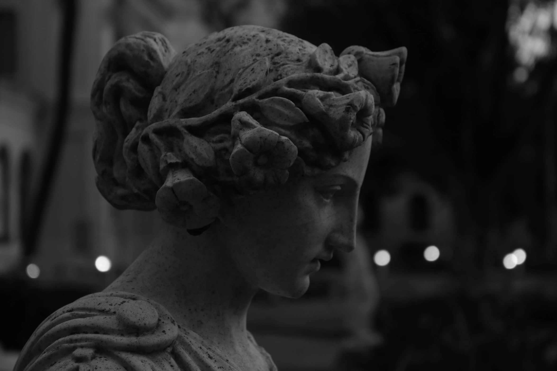 a statue of a woman with large head, wearing a head piece