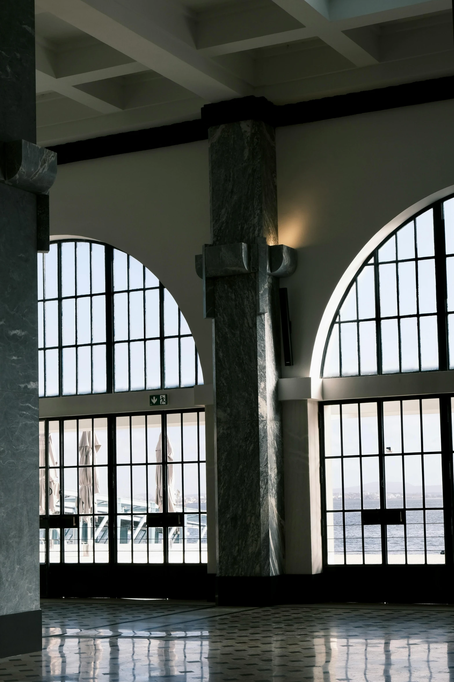 an empty lobby is seen with arched windows