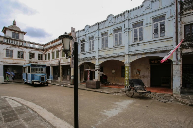 there is a old building with an old carriage in front