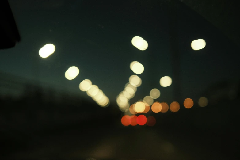 a view looking at a roadway in the city from car windshield