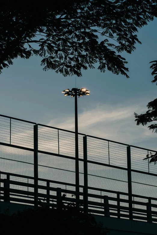 two airplanes flying over the top of a fence