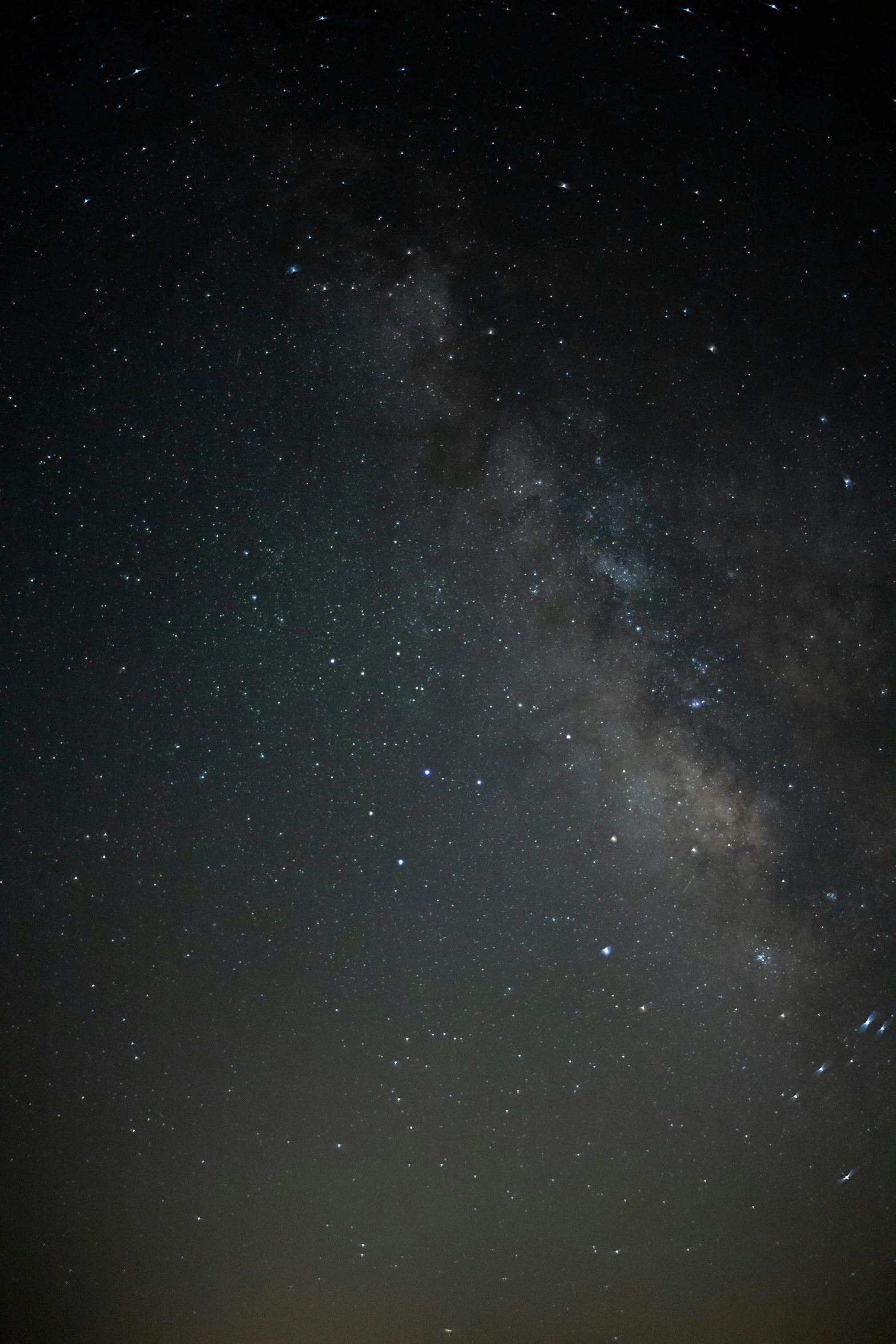 the night sky is full of stars and small clouds