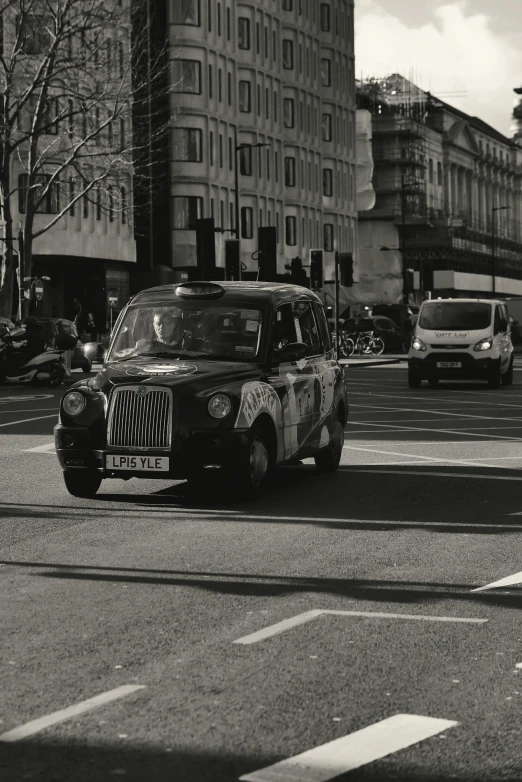 a taxi in an urban setting with tall buildings